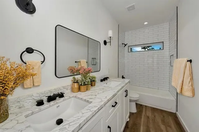 a bedroom with a bed and a potted plant