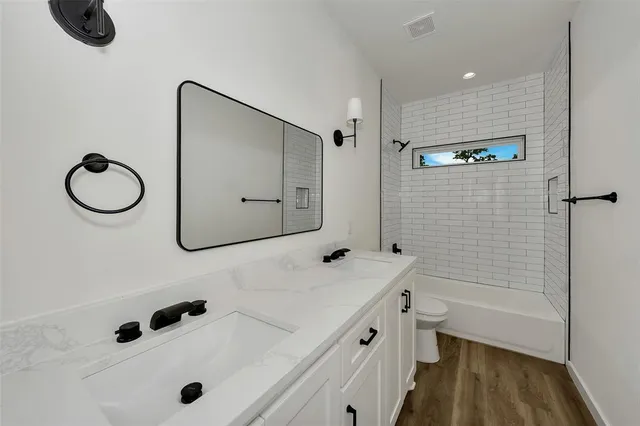 a bedroom with a bed and a potted plant