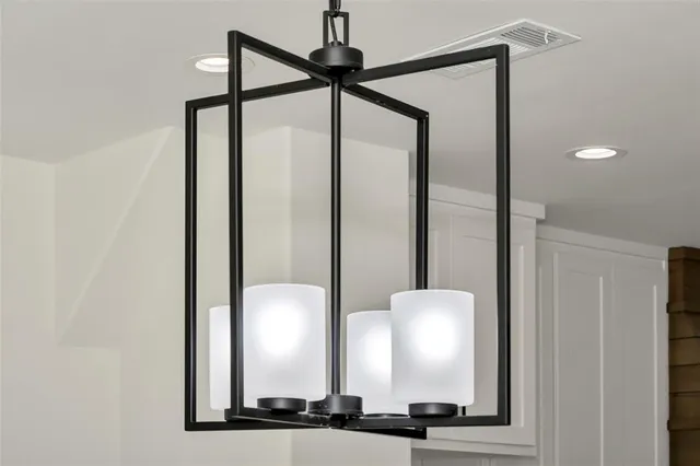 a kitchen with a refrigerator and white cabinets