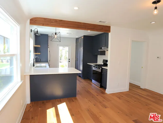 a view of kitchen with wooden floor and a large window
