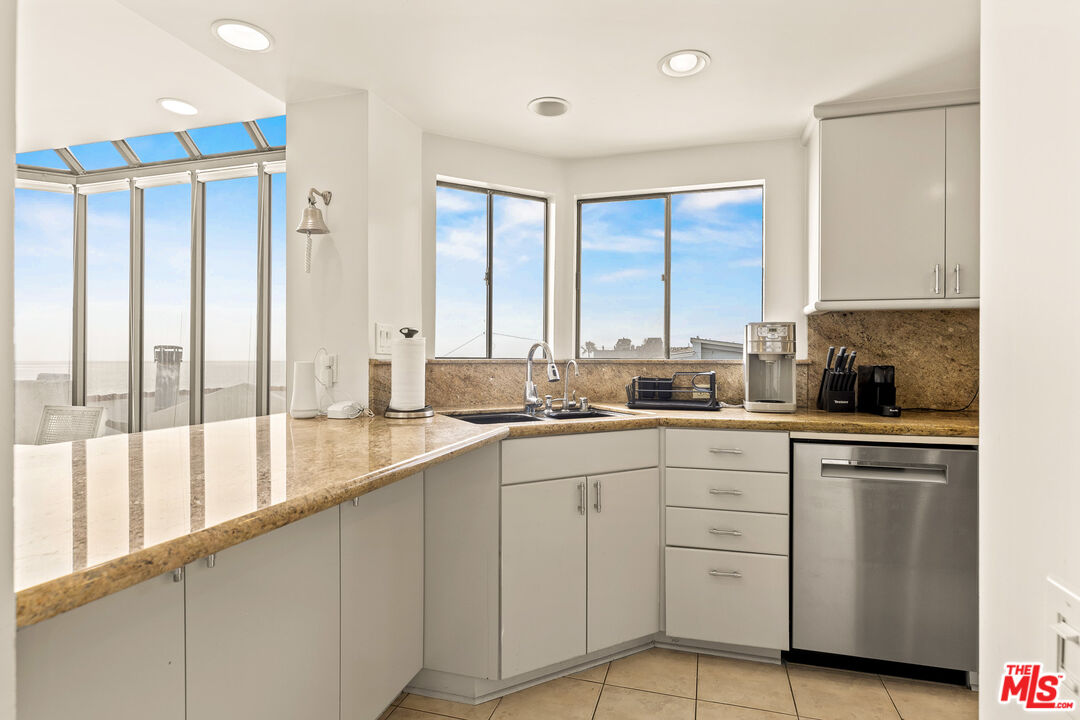 3616 The Strand, Unit C Manhattan Beach, CA 90266 - Photo 12 of 34 a large white kitchen with a large window