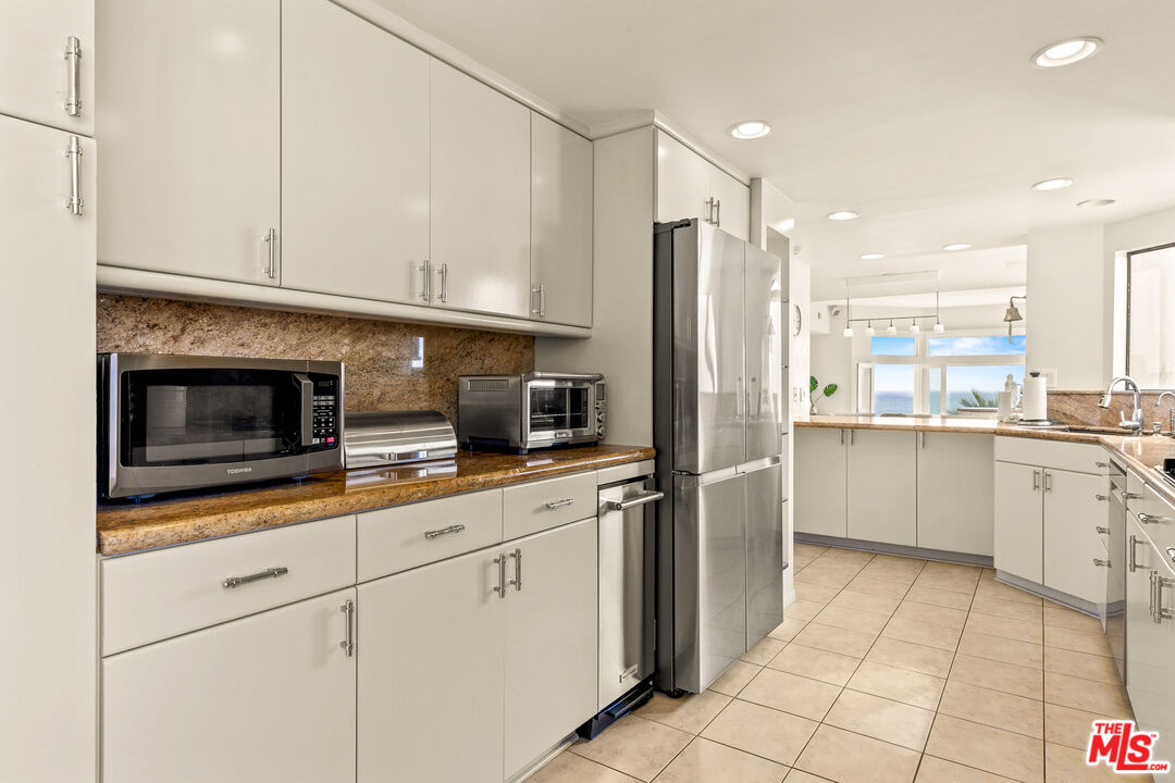 3616 The Strand, Unit C Manhattan Beach, CA 90266 - Photo 14 of 34 a kitchen with stainless steel appliances a refrigerator sink and microwave