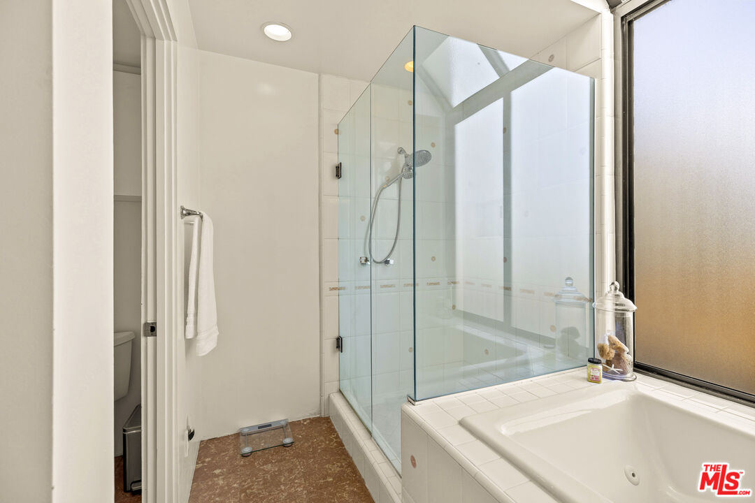 3616 The Strand, Unit C Manhattan Beach, CA 90266 - Photo 18 of 34 a bathroom with a tub sink and mirror