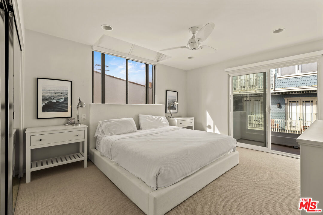 3616 The Strand, Unit C Manhattan Beach, CA 90266 - Photo 23 of 34 a bedroom with a large bed and a window