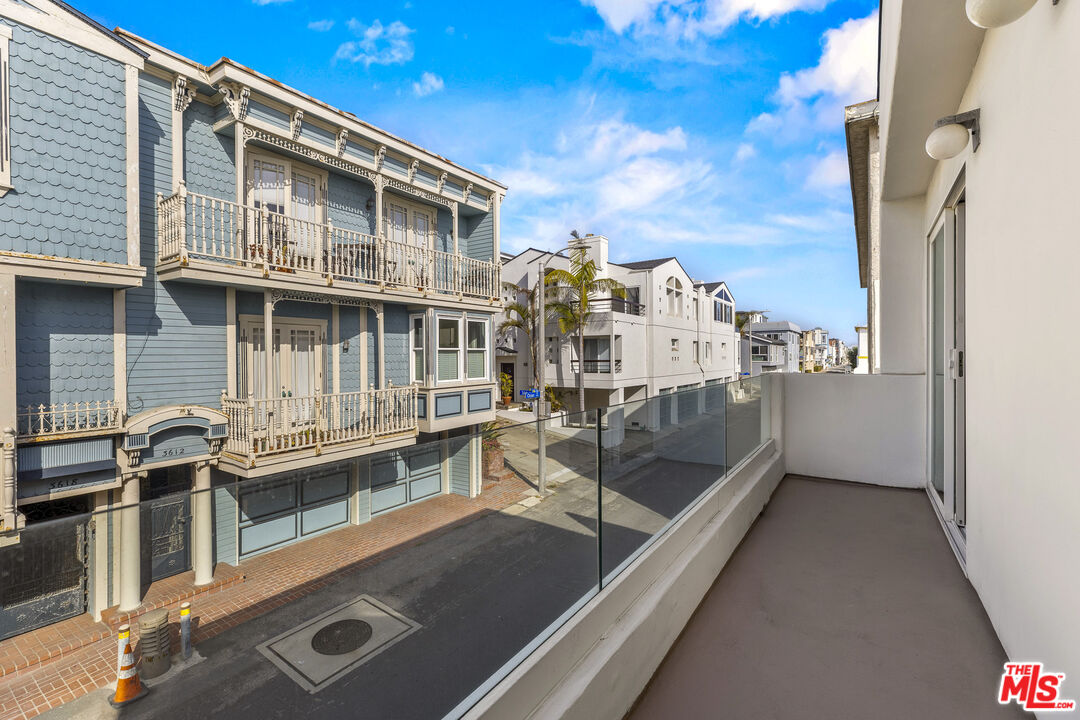 3616 The Strand, Unit C Manhattan Beach, CA 90266 - Photo 24 of 34 a view of a house with pool and wooden stairs