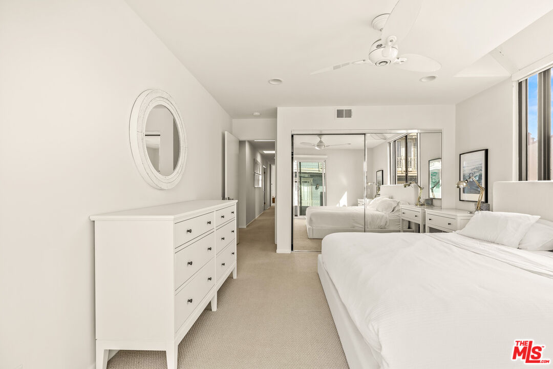 3616 The Strand, Unit C Manhattan Beach, CA 90266 - Photo 25 of 34 a large bedroom with bed mirror and window