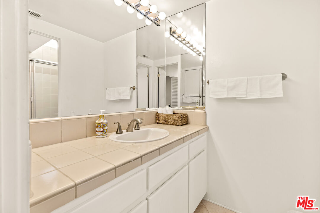 3616 The Strand, Unit C Manhattan Beach, CA 90266 - Photo 29 of 34 a bathroom with a sink and a mirror