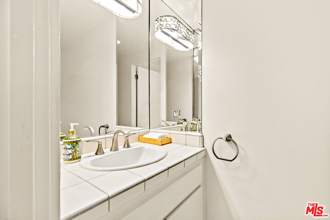 3616 The Strand, Unit C Manhattan Beach, CA 90266 - Photo 32 of 34 a bathroom with a sink vanity and mirror