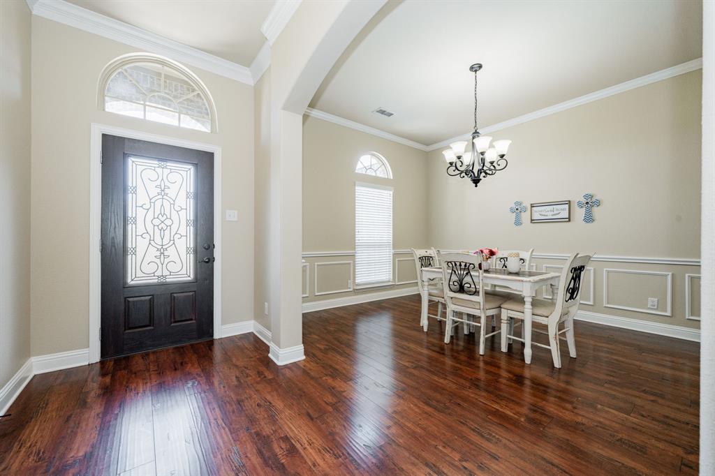 14176 Paterson Road Talty, TX 75126 - Photo 14 of 40 a view of a dining room with furniture and wooden floor