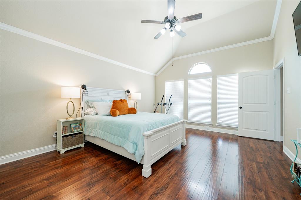 14176 Paterson Road Talty, TX 75126 - Photo 17 of 40 a bed room with a bed and a chandelier