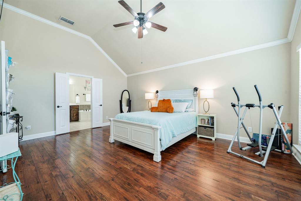 14176 Paterson Road Talty, TX 75126 - Photo 18 of 40 a bed room with a bed and a ceiling fan