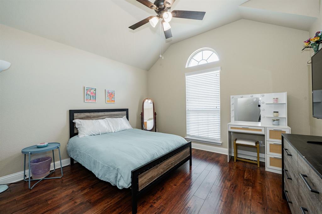 14176 Paterson Road Talty, TX 75126 - Photo 22 of 40 a bedroom with a bed and a chandelier