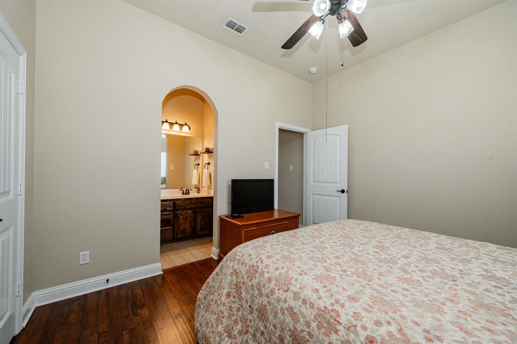 14176 Paterson Road Talty, TX 75126 - Photo 24 of 40 a bedroom with a bed and a flat screen tv