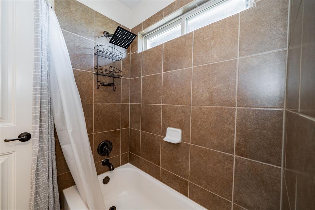 14176 Paterson Road Talty, TX 75126 - Photo 26 of 40 a bathroom with a sink toilet and shower