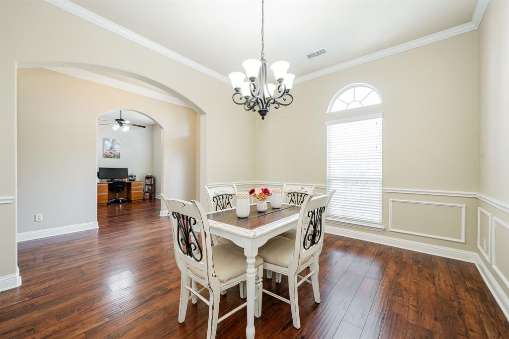 14176 Paterson Road Talty, TX 75126 - Photo 27 of 40 a view of a dining room with furniture a chandelier and wooden floor