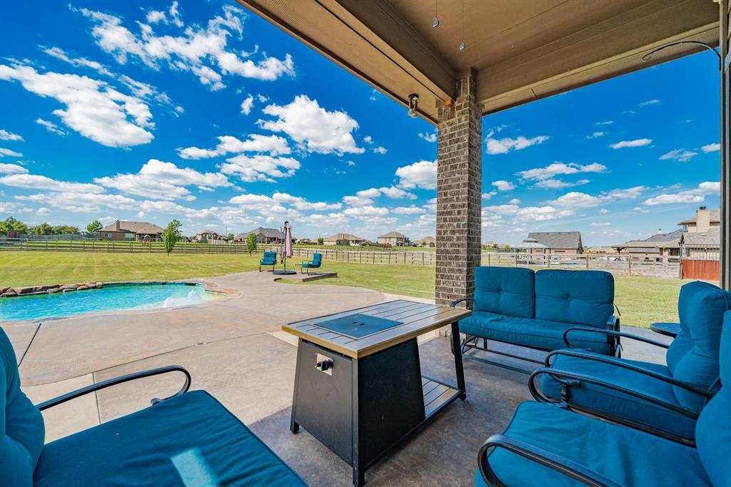 14176 Paterson Road Talty, TX 75126 - Photo 29 of 40 a view of swimming pool with outdoor seating and ocean view
