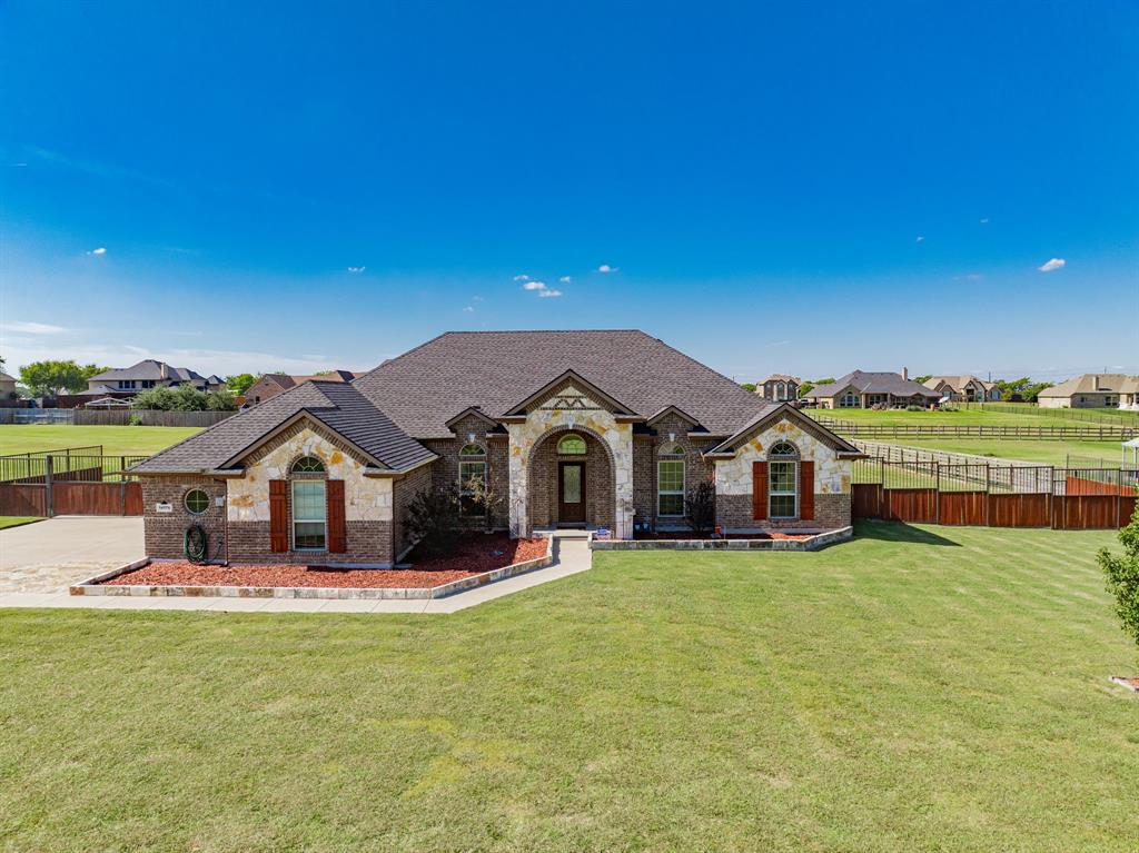 14176 Paterson Road Talty, TX 75126 - Photo 3 of 40 a front view of a house with a garden and yard