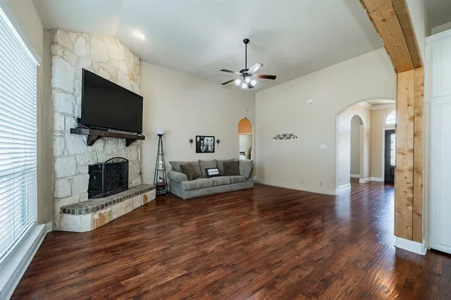 a view of a livingroom with furniture a flat screen tv and fireplace