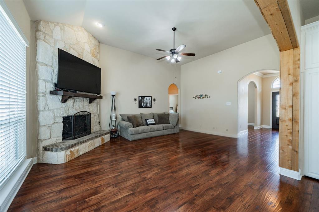 14176 Paterson Road Talty, TX 75126 - Photo 4 of 40 a view of a livingroom with furniture a flat screen tv and fireplace