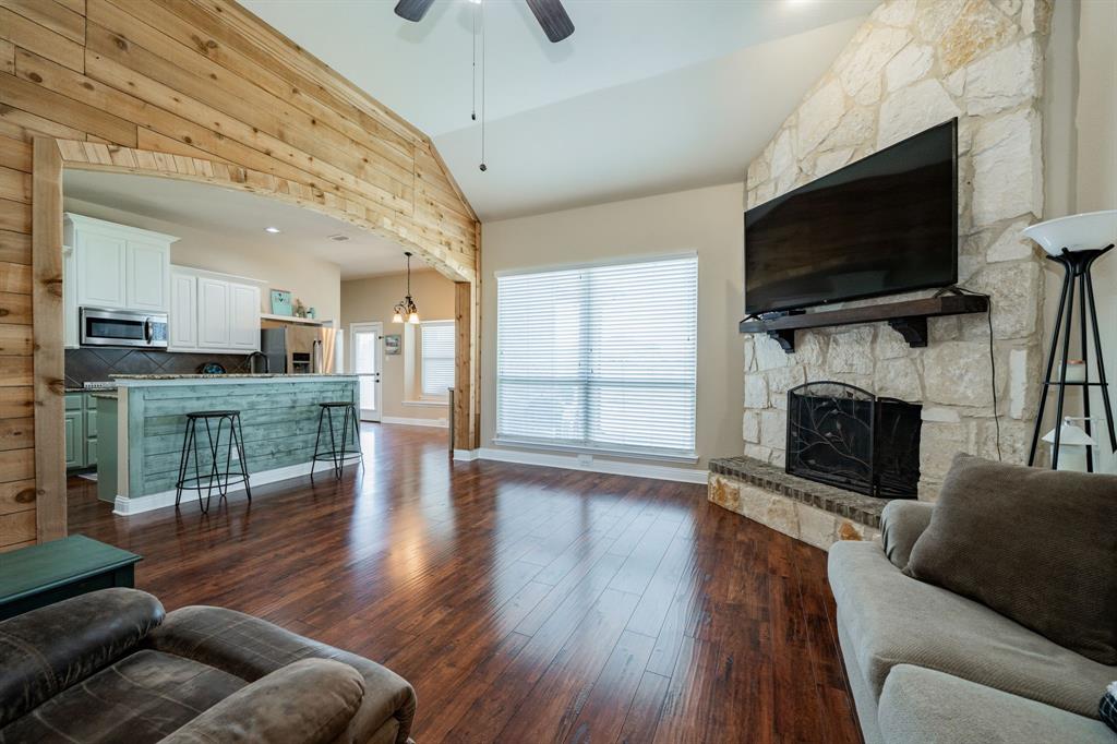 14176 Paterson Road Talty, TX 75126 - Photo 5 of 40 a living room with furniture a flat screen tv and a fireplace
