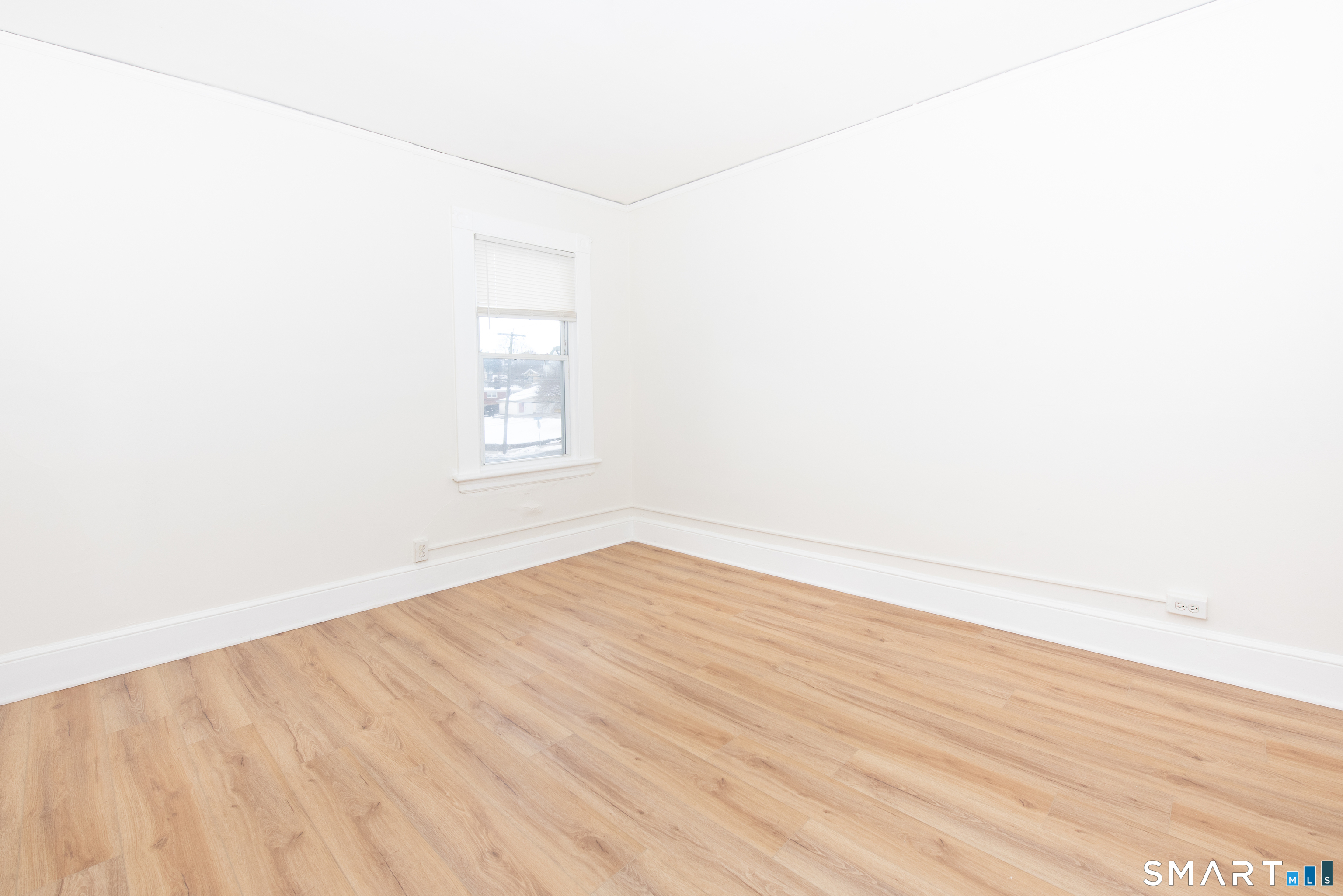 110 Beaver Street Ansonia, CT 06401 - Photo 13 of 31 a view of an empty room with wooden floor and a window