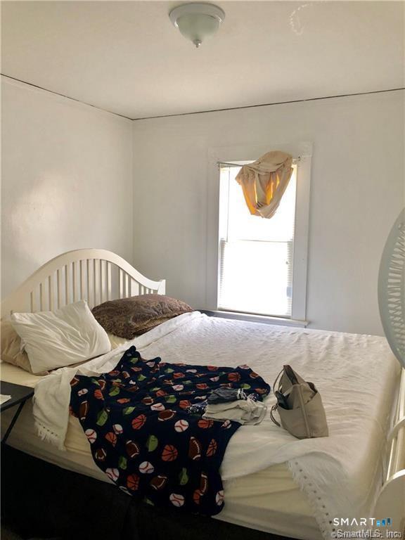 110 Beaver Street Ansonia, CT 06401 - Photo 20 of 31 a bedroom with a bed and wooden floor