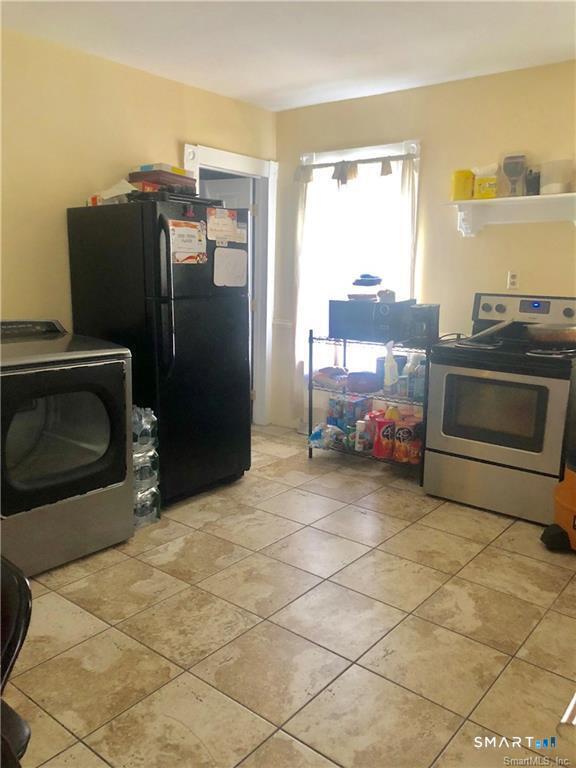 110 Beaver Street Ansonia, CT 06401 - Photo 22 of 31 a kitchen with stainless steel appliances granite countertop a refrigerator a stove and a sink with couches