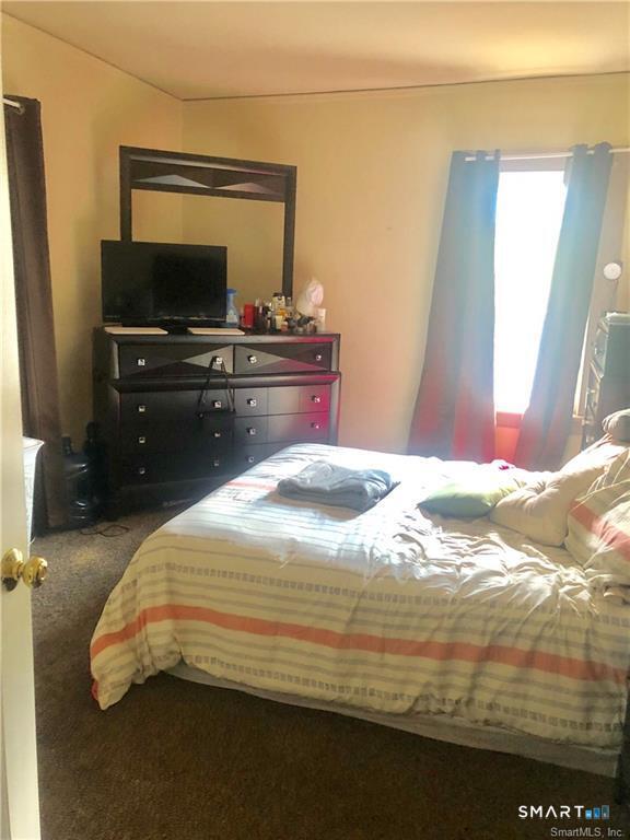 110 Beaver Street Ansonia, CT 06401 - Photo 25 of 31 a bedroom with a bed and a flat screen tv