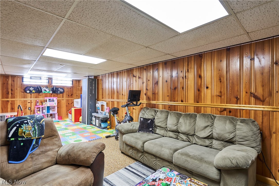 28322 Forest Road Willowick, OH 44095 - Photo 28 of 32 Rec room featuring a drop ceiling, wooden walls, and carpet floors
