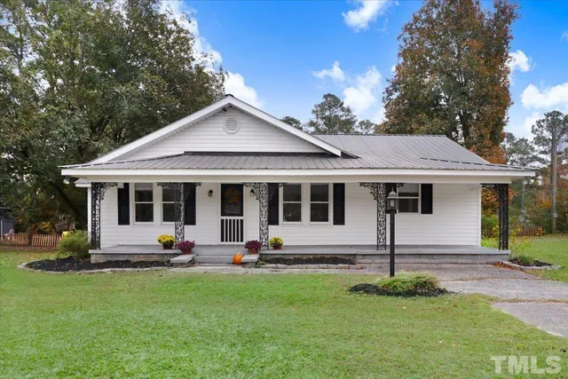 a view of a house with backyard and chairs