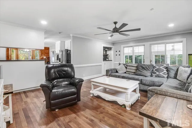 a living room with furniture ceiling fan and a rug