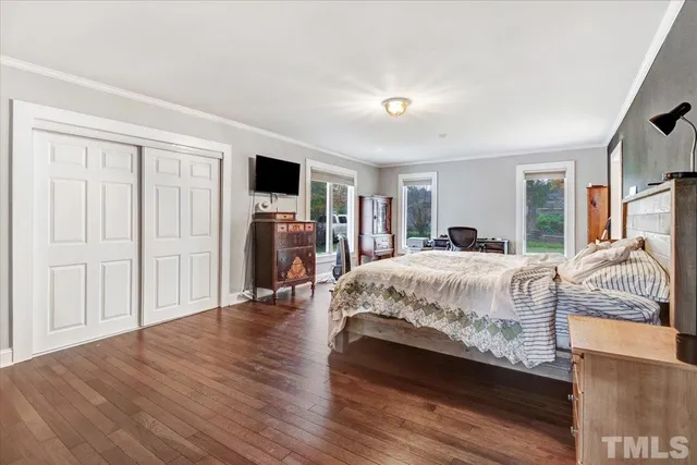a bedroom with a large bed and a tv