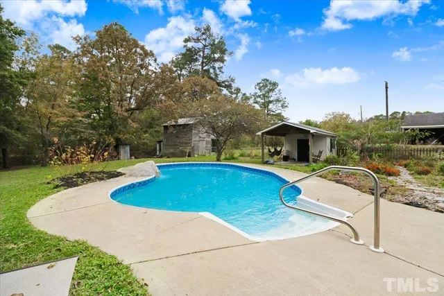 a view of a swimming pool with a yard
