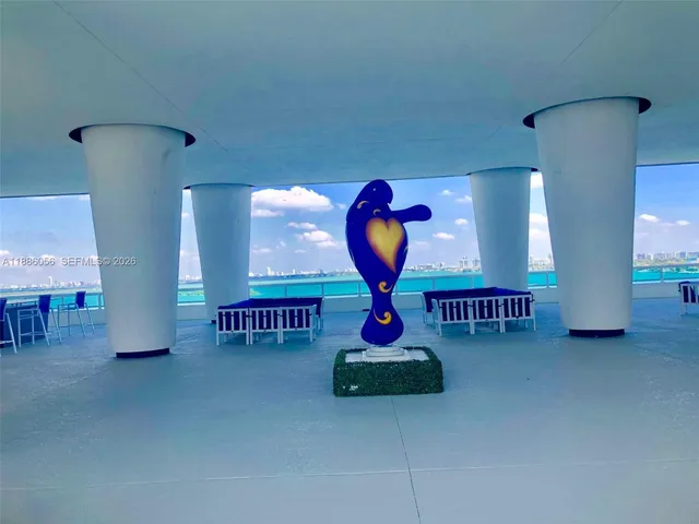 a living room with furniture and flowers