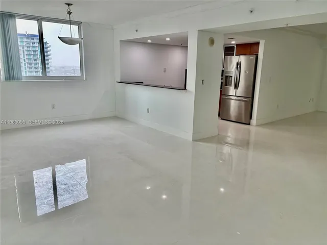 a view of kitchen with stainless steel appliances a refrigerator and cabinets