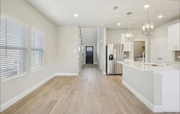 a large room with a lot of counter space and windows