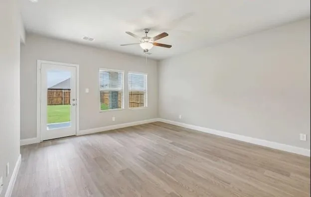 wooden floor in an empty room with a window