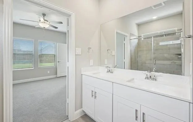 a bathroom with a sink double vanity and shower
