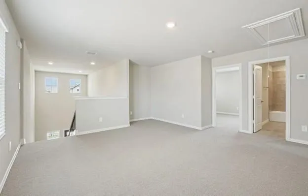 an empty room with white cabinet and mirrors