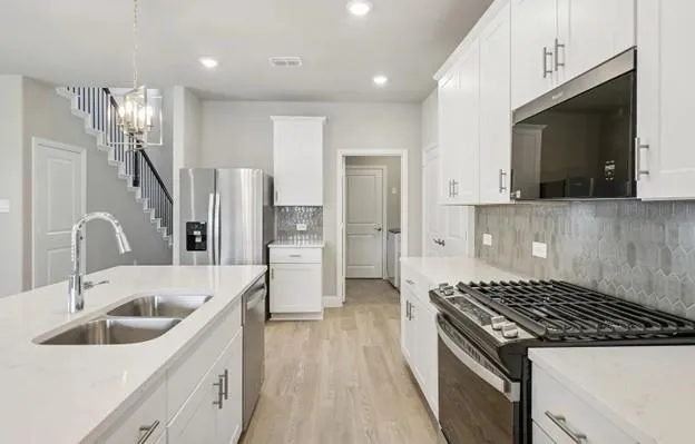 a kitchen with a sink stove and refrigerator