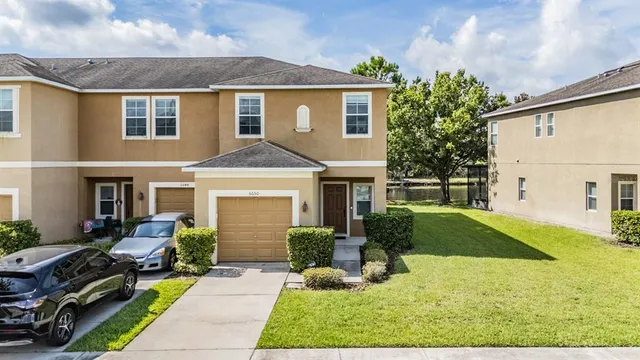 a front view of house with yard and green space