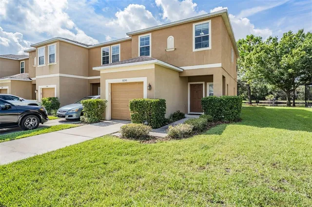 a front view of a house with a yard and garage