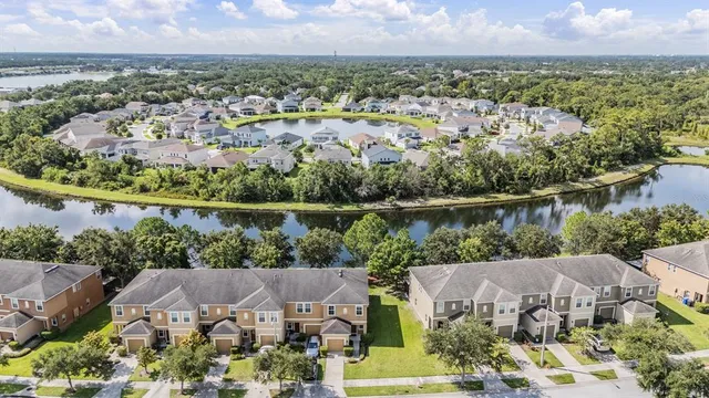 an aerial view of a house with a lake view