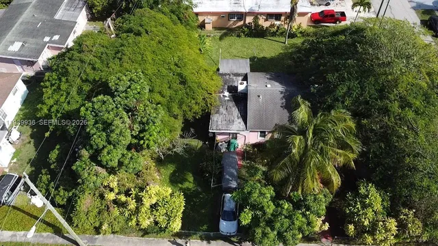 an aerial view of house with yard and outdoor seating