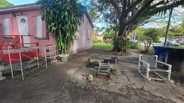 a view of a chairs and table in backyard