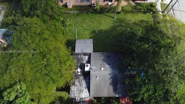 an aerial view of a house with a yard
