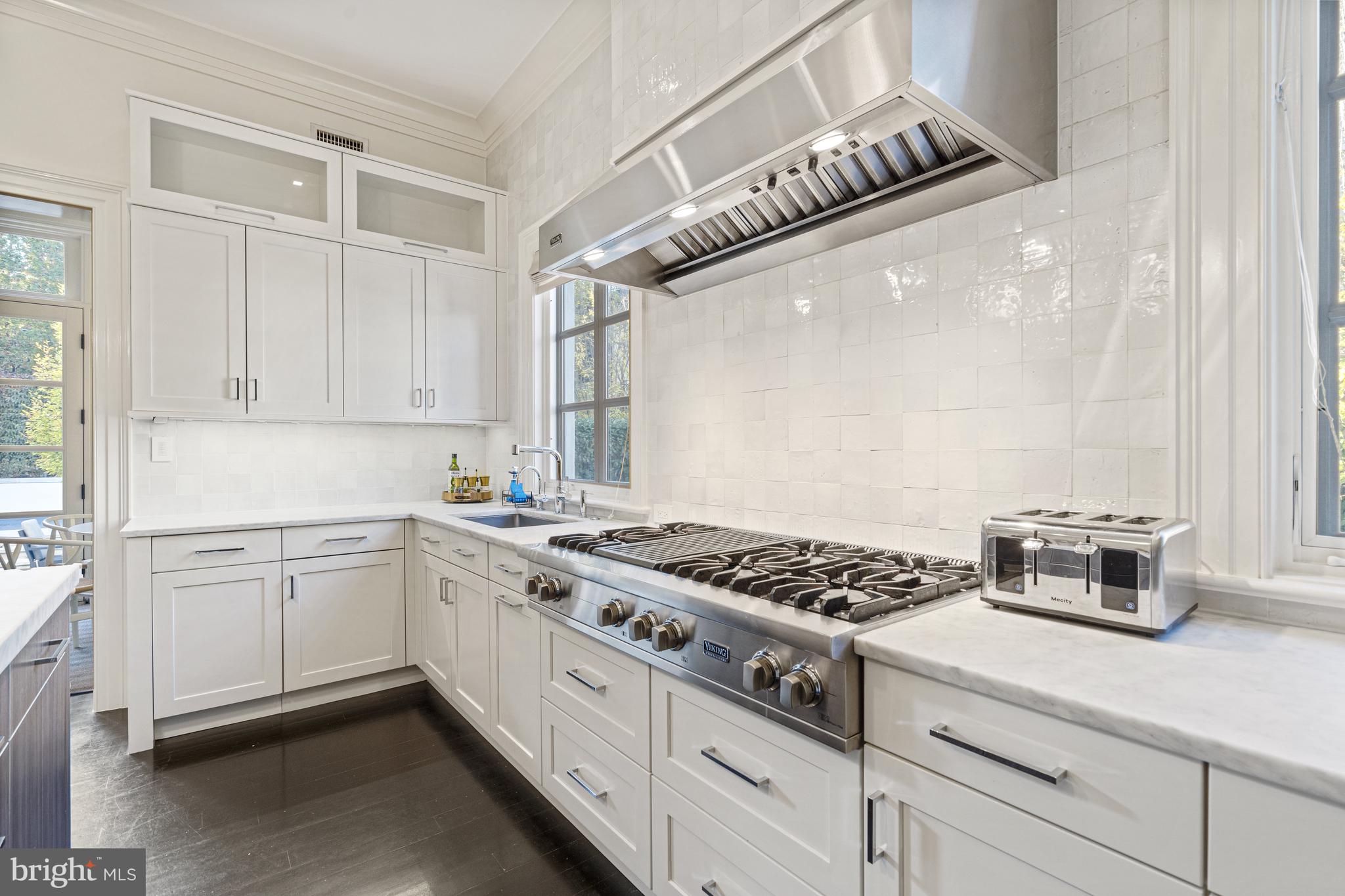 2109 Dunmore Lane Washington, DC 20007 - Photo 21 of 92 a kitchen with stainless steel appliances granite countertop a stove a sink and white cabinets