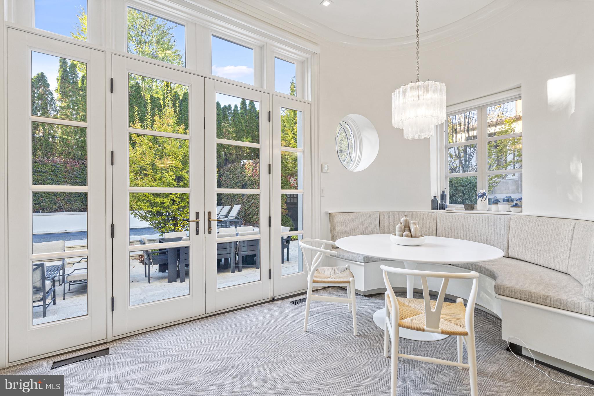 2109 Dunmore Lane Washington, DC 20007 - Photo 25 of 92 a dining room with wooden floor a chandelier a glass table and chairs
