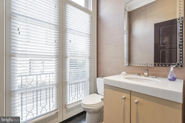 a spacious bathroom with a granite countertop sink a large mirror and a shower