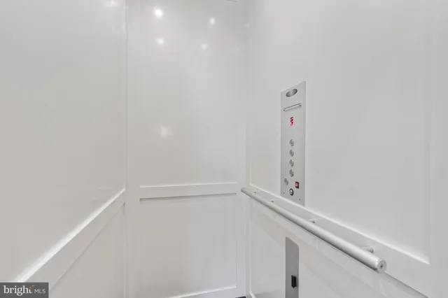 a spacious bedroom with a bed and a chandelier